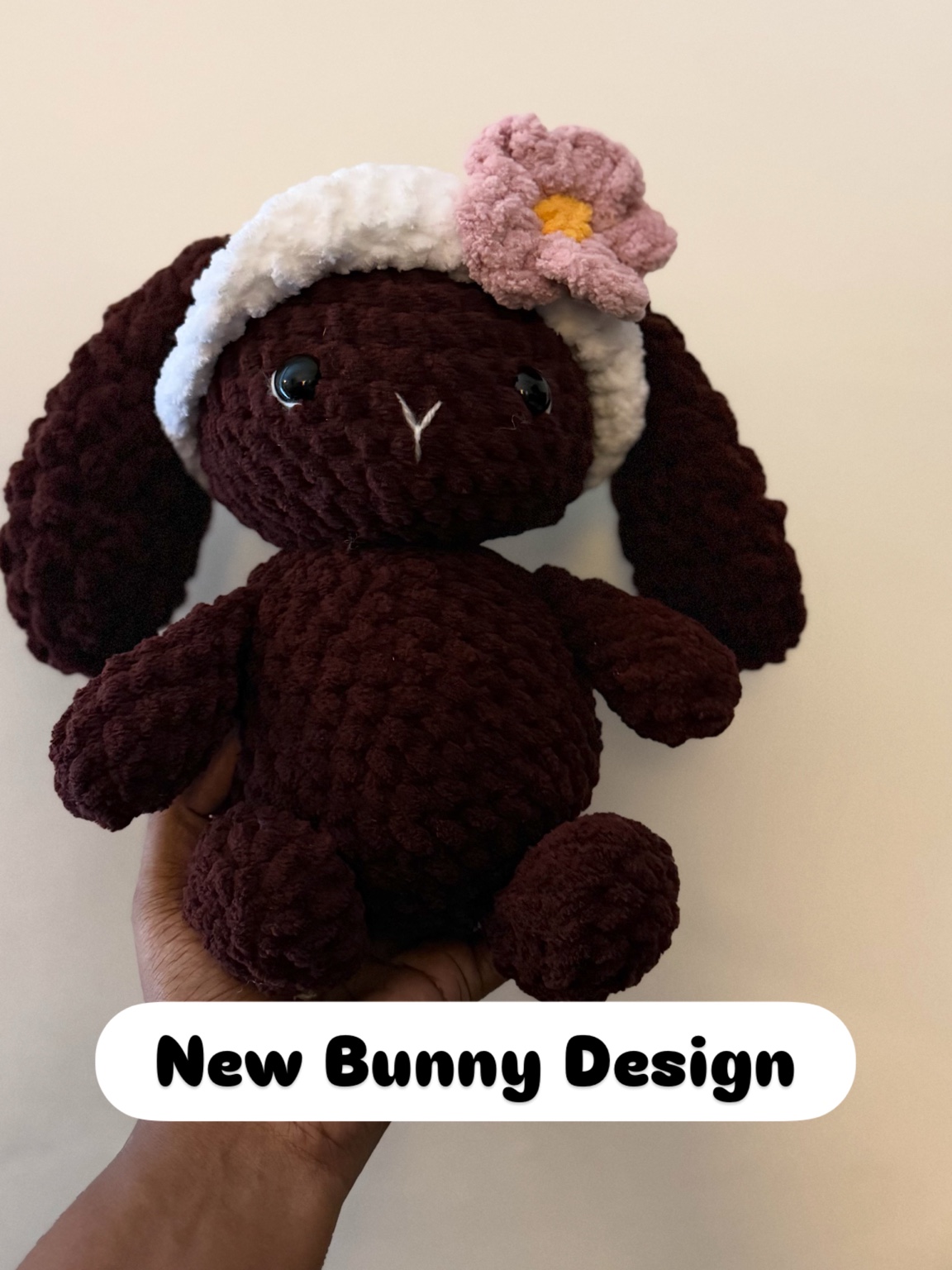 Handmade dark brown crochet bunny with cream headband and pink flower