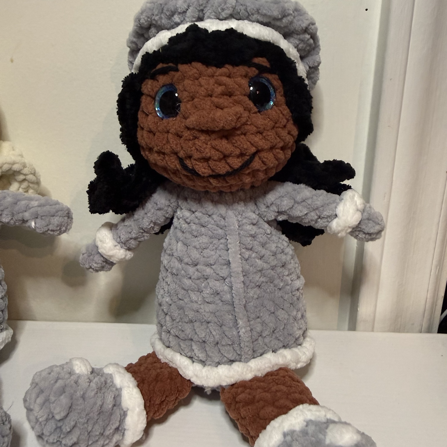 Handmade crochet character doll in a grey and brown costume