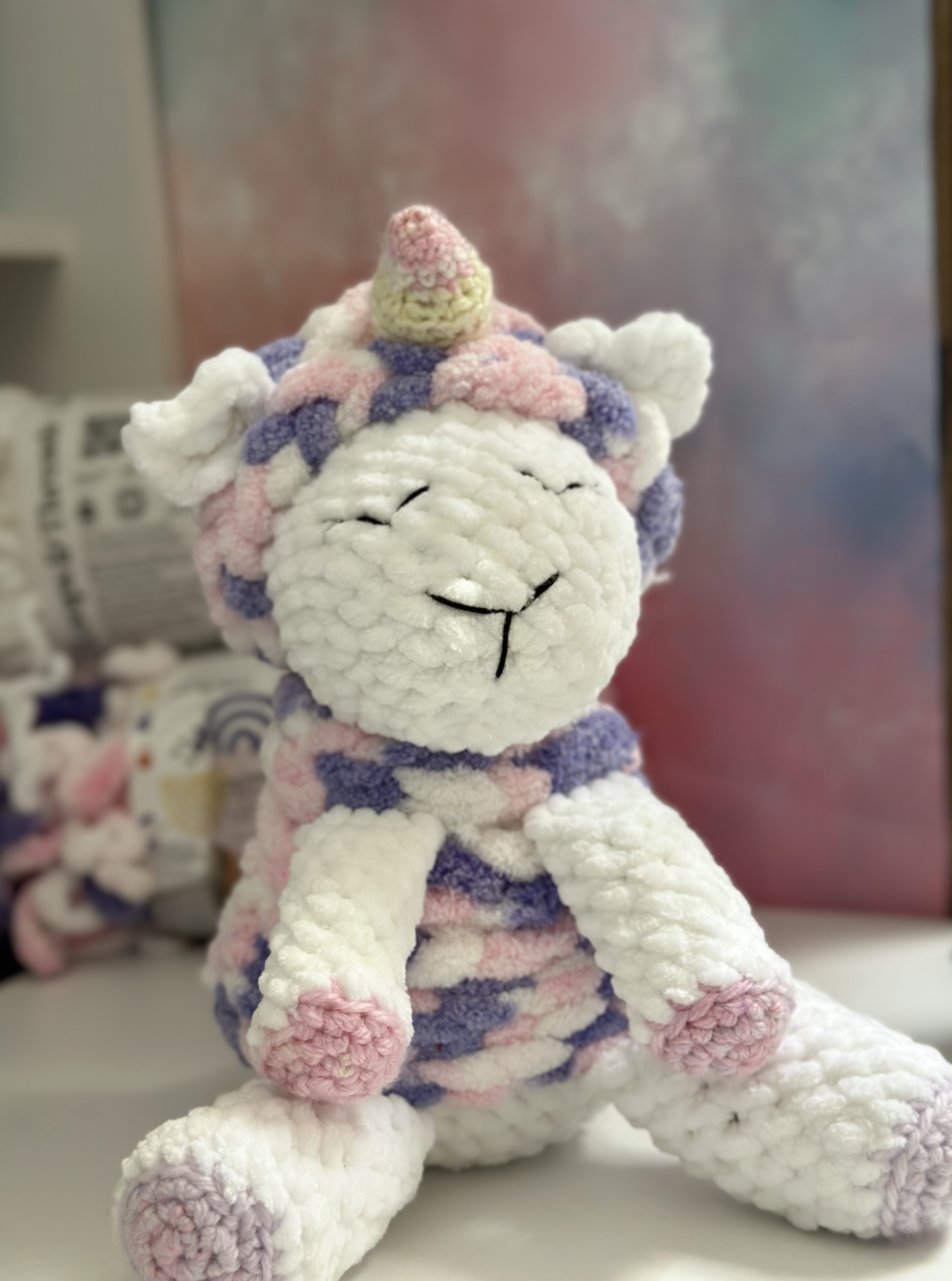 Handmade white crochet unicorn with pastel pink and purple mane